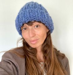 a woman wearing a blue knitted hat