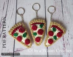 three crocheted keychains with slices of pizza on them