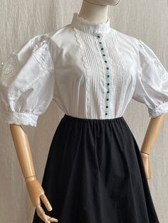 This vintage Austrian blouse with puff sleeves adds a touch of femininity and grace to any wardrobe. Whether you're dressing it up for a special occasion or wearing it casually, it's a beautiful and unique addition to your retro collection. Material: natural fabric Tag Size: 40, perfect fit on S/M/L Very good vintage condition Measurements (laying flat): Shoulders: 38 cm / 14,6" Armpit to armpit: 54 cm / 21,2" Length: 60 cm / 23,6" Sleeve: 35 cm / 13,7" ★A small boutique with unique and niche styles. All items select with love and passion. I hope you'll enjoy the collection. ★ Vintage clothes may come with minor flaws due to pre-loved wear. But most importantly it is a one-of-a-kind piece with its own character. ★Please use low-temperature water and natural laundry detergent for washing yo Blouse With Puff Sleeves, White Cotton Shirt, Retro Collection, Small Boutique, Retro Mode, Natural Fabric, Retro Stil, Lace Blouse, Natural Fabrics