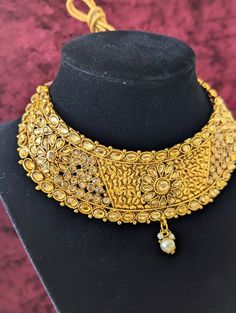 **Ships within 24 hours** Includes: a choker-style necklace with adjustable sizing, drop earrings (2), and maang tikka Introducing our stunning Indian necklace set, the perfect accessory for any traditional or cultural event. This set includes a choker necklace, maang tikka, and matching earrings, all crafted with a beautiful gold-plated finish and adorned with sparkling imitation diamonds and pearls. *Choker necklace: Features an adjustable cord to fit a variety of sizes and boasts a traditiona Adjustable Gold Jewelry Sets For Celebration, Festival Costume Jewelry Choker, Adjustable Metal Bridal Necklace, Adjustable Round Bridal Necklace For Festivities, Costume Jewelry Choker With Jewels As Gift, Gold Adjustable Necklace With Jewels, Adjustable Gold Necklace With Jewels, Adjustable Gold Metal Bridal Necklace, Adjustable Gold Bridal Necklace