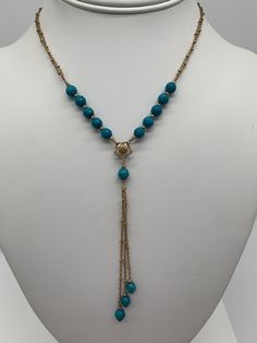 Delicate turquoise and gold lariat necklace. Faceted turquoise beads, gold vermeil flower bead and a triple strand 14K gold filled chain. 15.5 inches long with a 4 inch drop. Elegant Turquoise Beaded Lariat Necklace, Elegant Long Turquoise Necklace, Adjustable, Elegant Gold Turquoise Single Strand Necklace, Bohemian Gold Lariat Necklace With Dangling Beads, Gold Bohemian Lariat Necklace With Dangling Beads, Elegant Gold Single Strand Turquoise Necklace, Gold Single Strand Turquoise Necklace, Elegant Adjustable Long Turquoise Necklace, Gold Lariat Necklace With Dangling Beads