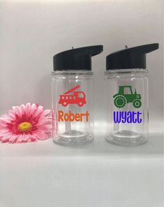 two personalized water bottles with one pink flower