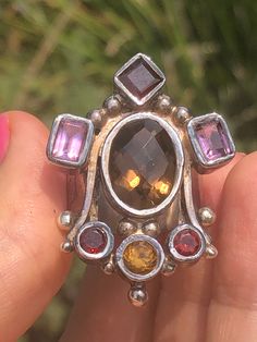 Amazing unique big gemstone ring smoky quartz, amethyst, Garnet and citrine. Ring sterling silver 925 Queen/ Royal Statement Size 10. Amazing ring. Extremely unique, I've never seen one like it. It truly feels like a medieval piece of jewelry that a queen or king would wear. Unusual and abstract piece. Would be perfect for a statement piece or even a Renaissance fair. The ring is well-made and solid. Signed 925. Bohemian Multi-stone Gemstones For Anniversary, Unique Multi-stone Amethyst Ring For Gift, Unique Multi-stone Amethyst Ring, Unique Multi-stone Citrine Rings, Unique Multi-stone Amethyst Ring In Sterling Silver, Unique Silver Topaz Gemstone Ring, Unique Citrine Gemstone Crystal Ring, Unique Multi-stone Amethyst Ring For Anniversary, Citrine Jewelry Stamped 925