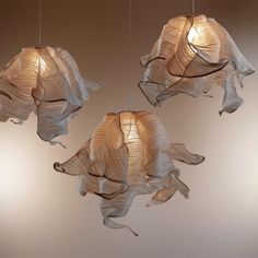 three hanging lights made out of paper leaves