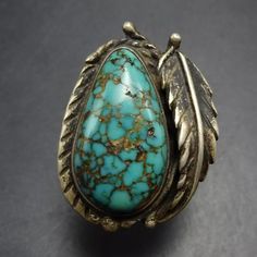 VINTAGE TURQUOISE with SPIDERWEB MATRIX STERLING SILVER RING DESCRIPTION: With a gorgeous cab of webbed matrix turquoise flanked by a sterling silver applied leaf, this ring will be a cherished addition to your collection of quality vintage Southwestern and Native American jewelry. MEASUREMENTS:  Ring face measures 1 1/8" x 7/8" RING SIZE: 7 1/2 WEIGHT:  9.5 grams SIGNED:  no STERLING:  unmarked, verified sterling silver Jewelry Measurements, Vintage Turquoise, American Jewelry, Native American Jewelry, Ring Size 7, Spider Web, Rings Statement, Sterling Silber, Matrix