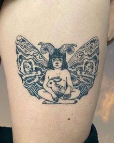 a tattoo on the back of a woman's thigh