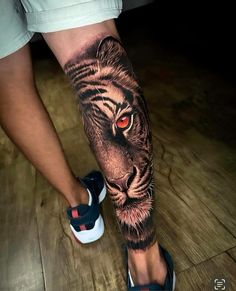 a man's leg with a tiger tattoo on it