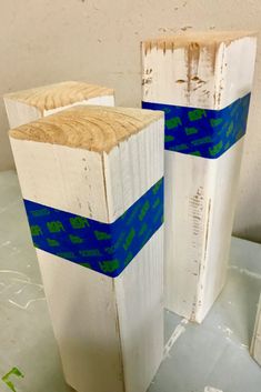 two pieces of wood with blue tape on them