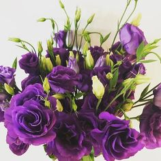 a vase filled with purple flowers on top of a table