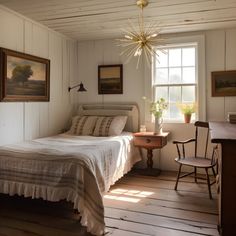 a bed sitting in a bedroom next to a wooden desk and chair on top of a hard wood floor