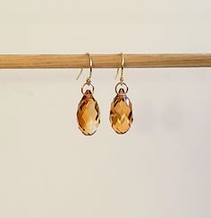 "- Simplicity is Elegance in this Swarovski Faceted Crystal CopperTeardrop Briolette Earring. See Photos #1-4. - Stunning piece has many Facets to capture the light in Copper, Caramel, Gold or Honey hues. - 14K Gold Filled Jump Ring Connectors now in petite 5mm size. - 14K Gold Filled Bali Ear Wire with Ball Ends. - 14K Gold Filled Leverback, Angular Hooks or Posts (Studs) with 4mm Ball Ends and Backs upon request at no cost. Give us a Note on Etsy at Checkout with your change request. - Drop Le Gold Gemstone Teardrop Earrings For Formal Occasions, Classic Drop Jewelry With Faceted Details, Gold Briolette Crystal Earrings For Wedding, Gold Briolette Earrings, Classic Gold Drop Crystal Earrings, Faceted Teardrop Crystal Earrings For Formal Events, Faceted Teardrop Crystal Earrings For Formal Occasions, Classic Faceted Drop Jewelry, Teardrop Faceted Crystal Earrings For Formal Occasions