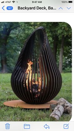 an outdoor fire pit sitting in the grass