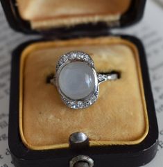 art deco ring, moonstone and diamonds ring, woman ring, estate ring, engagement ring, art deco engagement ring, platinum ring, gold and diamonds ring, luxury ring, natural moonstone and diamonds ring, real diamonds ring, gift for her Art Deco era ring (circa 1920) crafted in 18-karat gold, featuring a moonstone cabochon (10 x 9.4 x 5 mm) surrounded by 14 diamonds. The setting is embellished with a diamond on each side, and the back of the setting is finely decorated. Weight: 4g Size: 54 FR (7 US Authentic Art, Estate Ring, Woman Ring, Ring Luxury, Real Diamond Rings, Luxury Ring, Birthday Gift Ring, Ring Moonstone, Moonstone Cabochon