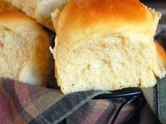 some bread is sitting in a basket on a blanket