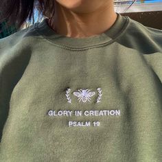 *SIZES ARE UNISEX* -I'd suggest your usual size for a more fitted look, or sizing up for a more relaxed fit. *these sweatshirts are extra comfy when oversized 🐝 "Glory in Creation Psalm 19" embroidered on a comfy cute crewneck. A sturdy and warm sweatshirt bound to keep you warm in the colder months. A pre-shrunk, classic fit sweater that's made with air-jet spun yarn for a soft feel and reduced pilling. Your new favorite sweatshirt! * 50% cotton, 50% polyester * Pre-shrunk * Classic fit with n Spring Sweater With Embroidered Logo For Streetwear, Spring Streetwear Sweater With Embroidered Logo, Spring Sweatshirt With Embroidered Logo And Crew Neck, Spring Crew Neck Sweatshirt With Embroidered Logo, Spring Crew Sweatshirt With Embroidered Logo, Spring Crew Neck Sweater With Embroidered Logo, Bee Sweater, Psalm 19, Christian Crewneck