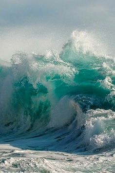 an ocean wave is breaking on the beach and it looks like they are in rough seas