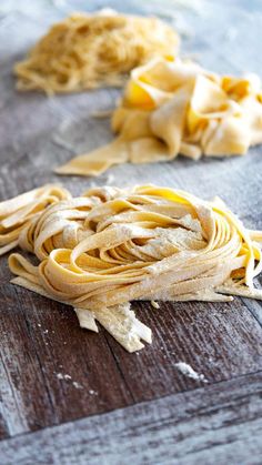 some uncooked pasta sitting on top of a wooden table