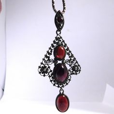 Amazing pendant with ornate 800 silver filigree cabochon garnets and seed pearls. The pendant measures 1 and ¾ inch tall by 1 and ¼ inch wide. It is on a more modern sterling silver box chain that measures 17.5 inches long. Pendant is marked 800, chain is marked 925 Italy. Excellent condition, very light wear for the age c. 1910. Carved Shell, Cameo Brooch, Silver Box, Seed Pearl, Long Pendant, Silver Filigree, Silver Pearls, Box Chain, Pearl Ring