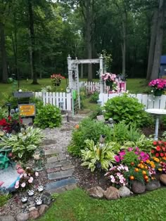 an outdoor garden with flowers and plants around it