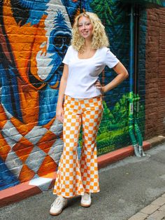 Look your best with these TN Checkerboard Pants. Crafted with a unique orange and white checkered pattern, they feature a flared design for an eye-catching look. The perfect pants for gameday! Checkerboard Pants, Checkered Pants, Perfect Pant, Tier Skirt, Checkered Pattern, White Trim, Soft Velvet, Asymmetric Hem, Cropped Pants