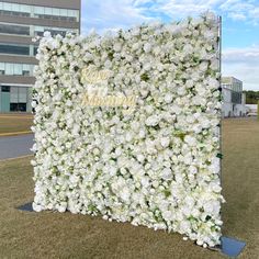 a large white flowered wall in front of a building