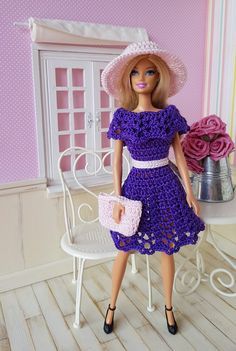 a barbie doll in a purple dress and hat holding a pink purse next to a white chair