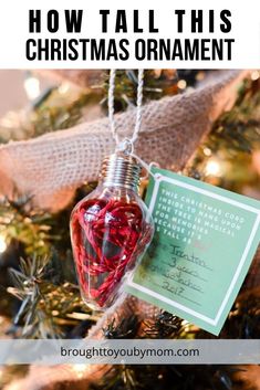 a christmas ornament hanging from a tree with a note attached to the tag