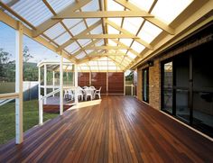 an outdoor deck with sliding glass doors and wood flooring is shown in this image