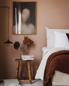 a bedroom with pink walls and white bedding