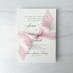 a wedding card with a pink ribbon on it