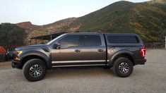 a large truck parked in front of a mountain