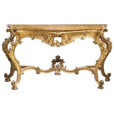 a golden console table with ornate carvings on it