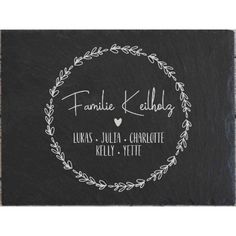 personalized slate coaster with the names and date printed on it in white ink, surrounded by leaves