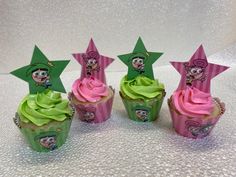 four cupcakes with green frosting and pink icing, decorated like stars