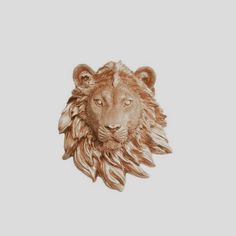 a gold lion head on a white background