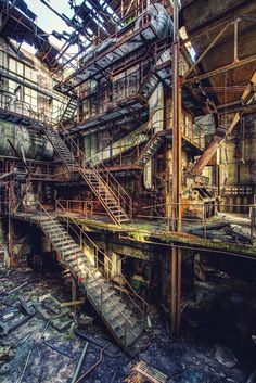 an abandoned building with lots of stairs and windows