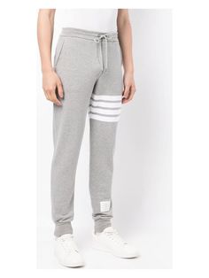 Hey there. Ever wanted to feel like you're lounging in your own personal cloud? These are your go-to for both style and comfort, thanks to the soft cotton and iconic Thom Browne clothing vibe. Crafted from 100% cotton for ultimate comfort Features the signature 4-bar stripe for a classic look Drawstring waist for a perfect fit Convenient side slit and rear welt pockets Made in Japan, ensuring top-notch quality | Thom Browne Men's 4-Bar Cotton Sweatpants in Grey | Size 2 | MJQ008H Cotton Sweatpants, Leather Cap, Mens Fall, Emilio Pucci, Sweaters Knitwear, Grey Cotton, Thom Browne, Denim Pant, Denim Top