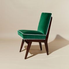 a green chair sitting on top of a white floor