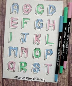 the letters and numbers are drawn in different colors on paper with marker pens next to them