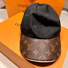 Brand New Louis Vuitton “Get Ready Cap”. Purchased In February While Vacationing. Accidentally Got A Size M, But My Head Is A Large. Wore For Half A Day And Found It Too Uncomfortable. Price Is Firm: $600 Designer Baseball Cap With Adjustable Short Brim, Designer Baseball Cap With Short Brim, Designer Adjustable Baseball Cap With Short Brim, Luxury Black Cap, Luxury Black Adjustable Hats, Designer Black Cap, Designer Adjustable Black Baseball Cap, Luxury Brown Cap, Luxury Brown Visor Baseball Cap