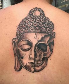 the back of a man's head with a skull and buddha mask on it