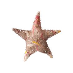 a decorative starfish is hanging on the wall in front of a white background, it appears to be made out of fabric