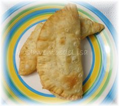 two pastries on a colorful plate with blue and yellow stripes