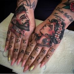 two people with tattoos on their hands