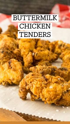 some fried food sitting on top of a white paper towel next to a red and white checkered table cloth