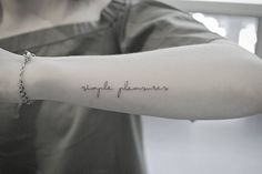 a woman with a tattoo on her arm that reads, simply plannerer in cursive writing