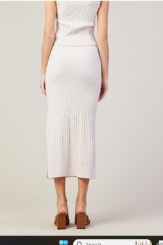 Indulge in timeless style with our Cable Knit Midi Skirt. Crafted from luxuriously soft yarn, this skirt boasts a classic cable knit pattern that adds depth and texture to your look. The midi length is effortlessly chic, while the flattering side slit adds a touch of modern edge. Perfect for transitioning from day to night, this versatile piece can be dressed up or down to suit any occasion. Experience the perfect blend of comfort and sophistication with this must-have skirt. Cable Knit Pattern, Maxi Jumpsuit, Knit Midi Skirt, Swimwear Sets, Knit Midi, Long Sleeve Midi, Knit Pattern, Skirt Leggings, Soft Yarn