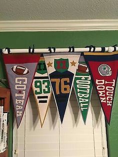 the football pennants are hanging from the ceiling in front of an open garage door