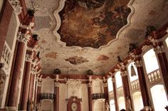 an ornately decorated room with painted ceilings