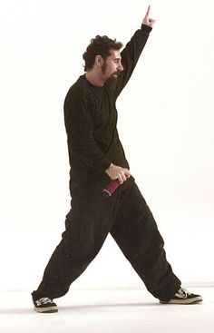 a man in black is throwing a frisbee on a white background with his hand up